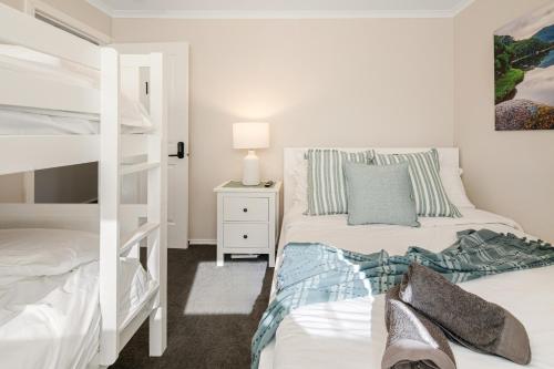 a bedroom with two beds and a bunk bed at Summery 4BR Home by Mel Airport, CBD & Watergardens in Sydenham