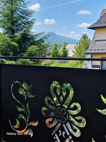 a metal fence with a flower painted on it at Pokoje Gościnne U Moniki i Daniela in Zakopane