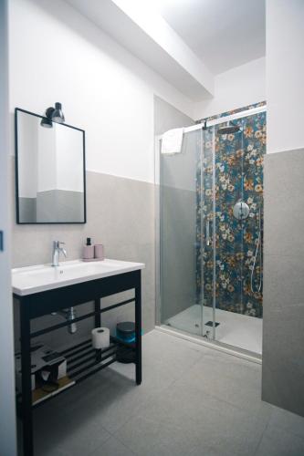 a bathroom with a sink and a shower at Dal Monaco - casa blu in Castellana Grotte