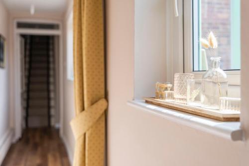 a window sill with a glass vase on it at Charming 2 Bed Property in Upton