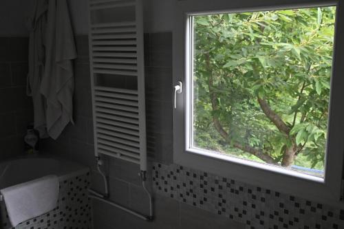 a bathroom with a window and a sink and a tub at SemiVillage in La Lima San Marcello Piteglio