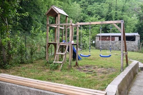 a playground with a swing set in a yard at SemiVillage in La Lima San Marcello Piteglio