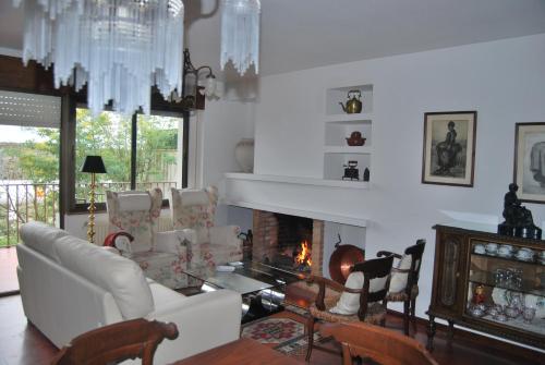 a living room with a couch and a fireplace at Casa rural Puente Mocho in Ledesma