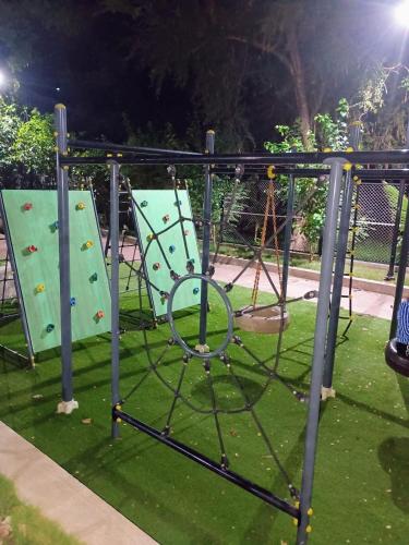 an empty playground with two slides and a swing at Aapka home in Neral
