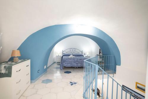 a bedroom with a blue and white room with a bed at Casa Zaffiro in Procida
