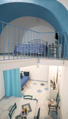 a room with a bed and a blue ceiling at Casa Zaffiro in Procida