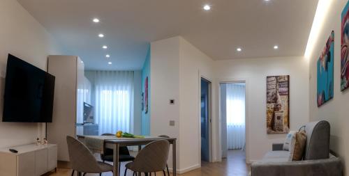 a living room with a table and chairs at PALAZZO NOVA luxury apartments in Acerra