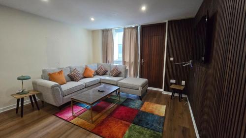 a living room with a couch and a colorful rug at Charming Newly Renovated 2 Bed with free parking in Galway