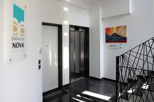 a hallway with two elevators in a building at PALAZZO NOVA luxury apartments in Acerra