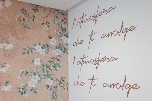 a page of a book with flowers on a wall at PALAZZO NOVA luxury apartments in Acerra