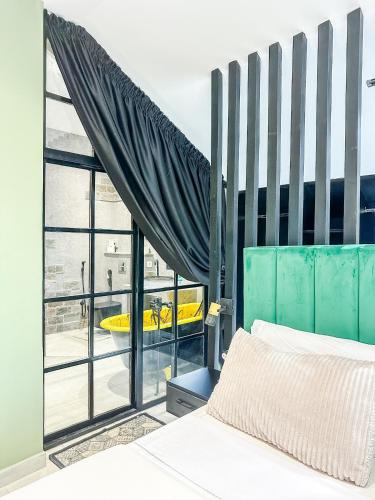 a bedroom with a bed and a large window at La Finca - 3BR Seaside Villa with Private Pool & BBQ in Tangier