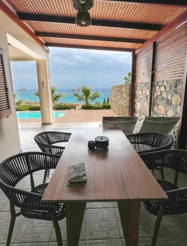 a wooden table and chairs on a patio at Krinakia Villas in Xerokampos