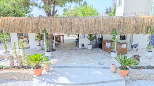 a pavilion with potted plants on a patio at InOne Bitez Hotel in Bodrum City