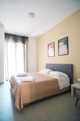 a bedroom with a large bed and a window at Dal Monaco - casa verde in Castellana Grotte
