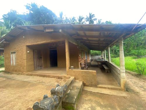 a small house with a roof on top of it at Hideout Rawana Meenure in Meemure