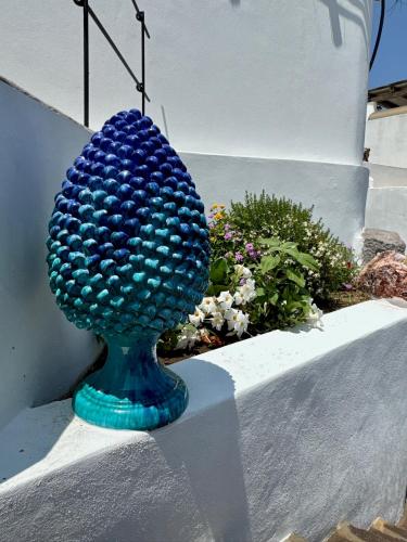 a blue glass sphere is sitting on a ledge at Kyma Suites in Panarea