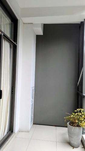 a white room with a door and a potted plant at Royal Lion Hotel - Kandy Road, Galagadara in Galagedara