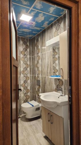 a bathroom with a sink and a toilet at Trend Suite Hotel in Uzungöl