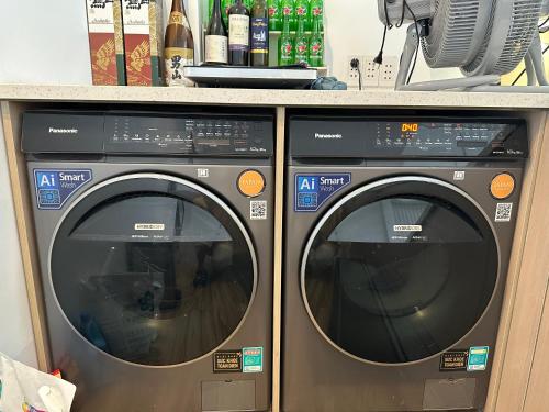 two washing machines are sitting next to each other at Nemaru urban stay in Ho Chi Minh City