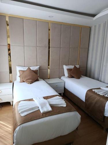 a hotel room with two beds with towels on them at Burj Al Istanbul in Istanbul