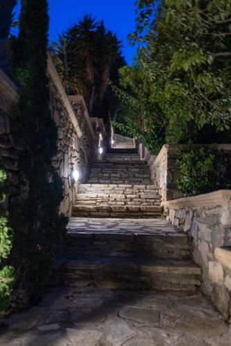 a set of stairs with lights at night at Krinakia Villas in Xerokampos