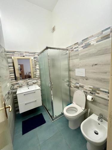 a bathroom with a shower and a toilet and a sink at Casamare in Torre Forte