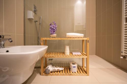 a bathroom with a sink and a white toilet at Albergo La Rocca in Brisighella