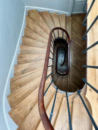 a spiral staircase in a house with a wooden floor at Le Parc Maison d'hotes de Charme in Provins