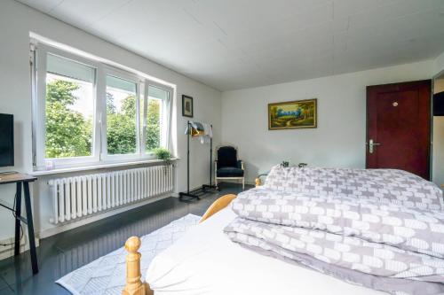 a bedroom with a bed and a television in it at Sunny Home near Zurich Airport in Zürich