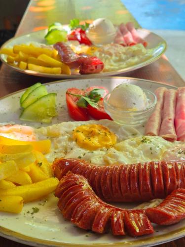 two plates of food on a table with breakfast foods at "Vista Paradiso" - Jaz - lake view in Višegrad