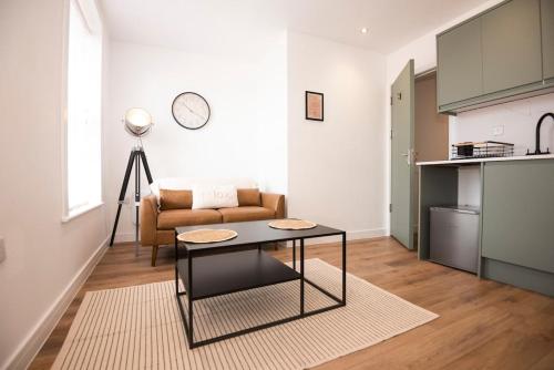 a living room with a couch and a table at Cosy 2-Bed Apartment in Penarth Town Flat 1 in Cardiff
