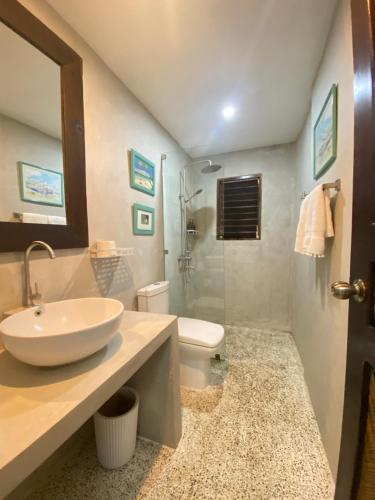a bathroom with a sink and a toilet at Casa Manalo Guest House in Puerto Princesa City