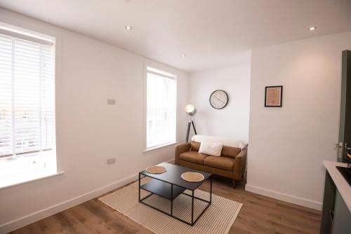 a living room with a couch and a table at Cosy 2-Bed Apartment in Penarth Town Flat 1 in Cardiff