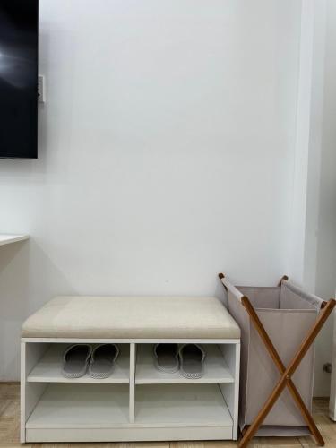 a white cabinet with a cushion on top at Nemaru urban stay in Ho Chi Minh City