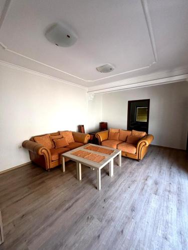 a living room with a couch and a table at Home Base Apartments in Skopje