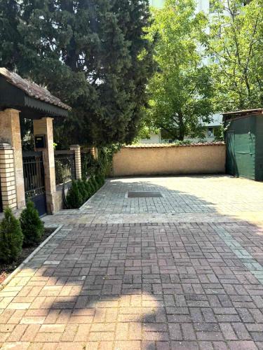 a brick driveway in front of a house at Home Base Apartments in Skopje