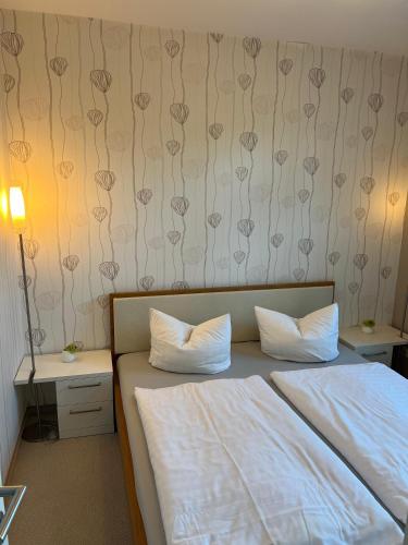 a bedroom with two beds and a wall with hearts at Haus Seezeit in Malchow