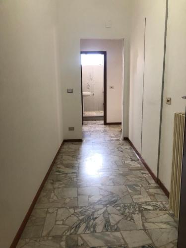 a corridor of an empty room with a stone floor at Casa La Lavanda in Nicosia