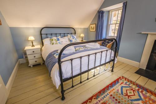 a bedroom with a bed with a metal frame at Craigendarroch No 2 in Acharn