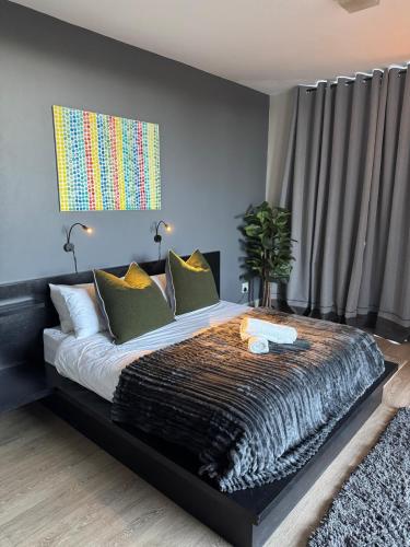 a bedroom with a large bed with a black frame at Suite Vos in Hermanus