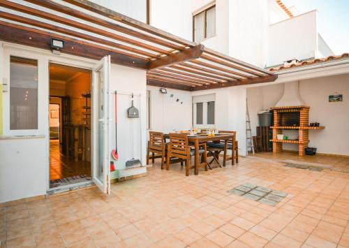 a dining room with a table and chairs at Charming T3 with patio, beach and surf in Peniche