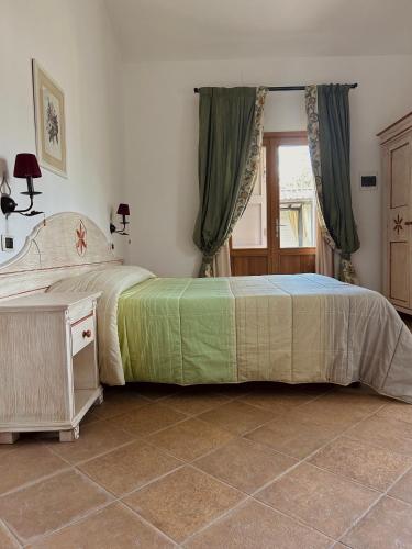 a bedroom with two beds and a tiled floor at Il Casale Mancini in Vada