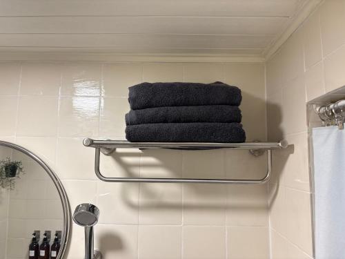 a stack of towels on a towel rack in a bathroom at Ire Stay in Seoul