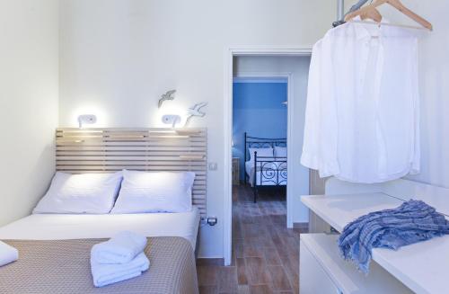 a bedroom with a bed with a wooden headboard at Amaryllis House Lefkada in Lefkada