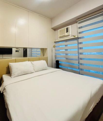 Ένα ή περισσότερα κρεβάτια σε δωμάτιο στο Staycation Champ Close to Your Heart
