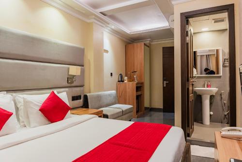 a hotel room with a bed and a bathroom at Coral Grand Beach & Spa in Hulhumale