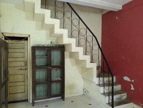 a set of stairs in a room with a door at Bachelor's Homestay in Aurangabad
