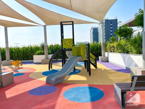 a playground with a slide on a carpet at Tranquil 1BR Escape with Pool View in Meydan in Dubai
