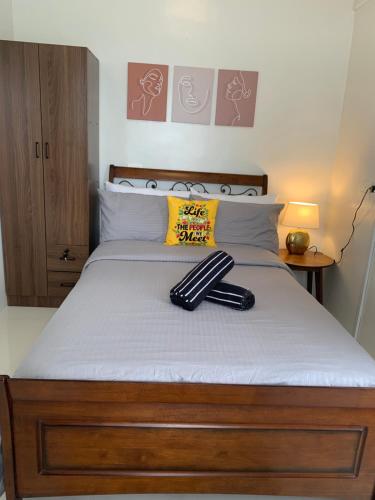 a bed with a pair of umbrellas sitting on it at Modern Condo, Sea View, Fast Wifi, Cafe, Panglao in Dauis