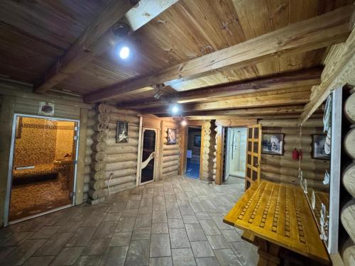 a wooden cabin with a bench in the middle of a room at Hotel Doi Haiduci in Orhei